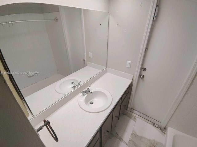 bathroom with vanity and marble finish floor