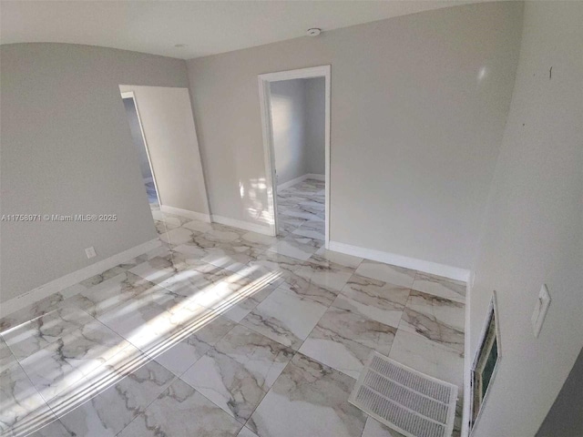 interior space with baseboards and marble finish floor