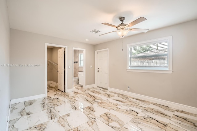 1281 Wyndcliff Dr, Wellington, FL 33414 - unfurnished bedroom with a ceiling fan, visible vents, baseboards, marble finish floor, and connected bathroom