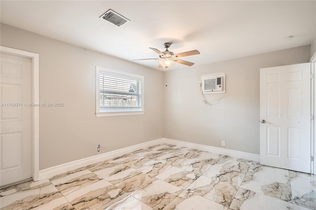 1281 Wyndcliff Dr, Wellington, FL 33414 - empty room with visible vents, ceiling fan, baseboards, a wall unit AC, and marble finish floor