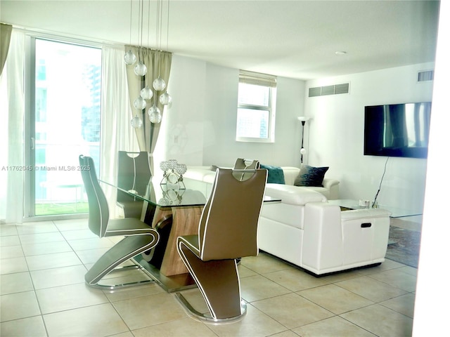 dining area featuring light tile patterned flooring and visible vents