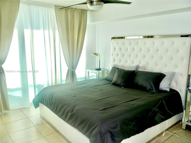 bedroom featuring tile patterned floors, multiple windows, and ceiling fan