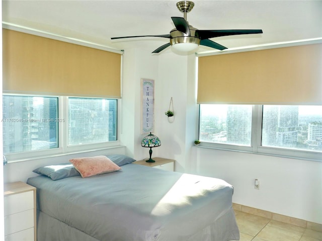 bedroom featuring light tile patterned flooring and ceiling fan