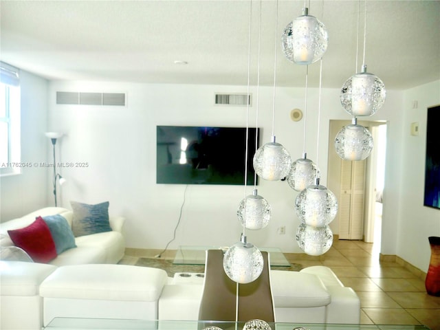 tiled living room featuring visible vents