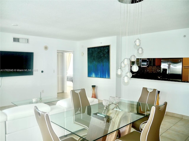 dining area featuring light tile patterned flooring and visible vents