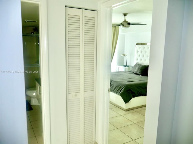 bedroom with light tile patterned floors and a closet