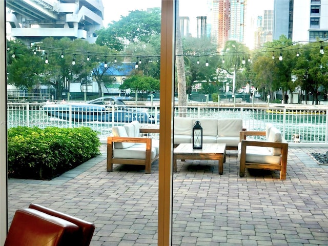 view of patio featuring an outdoor living space and fence