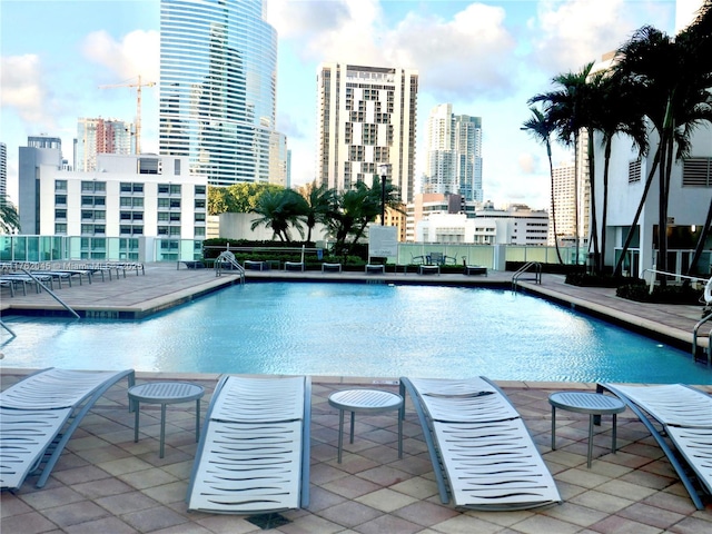 pool with a view of city and a patio