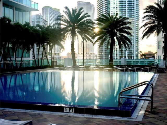 view of swimming pool with a view of city