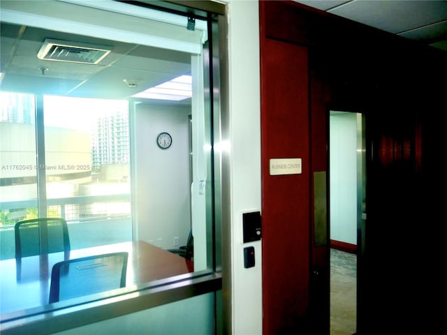 hall featuring visible vents and elevator