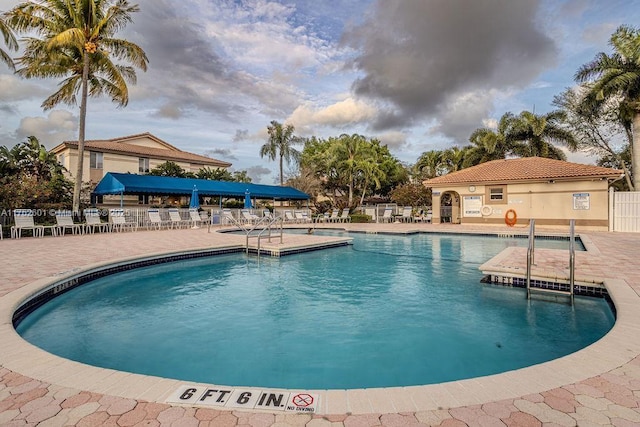 community pool featuring a patio area and fence