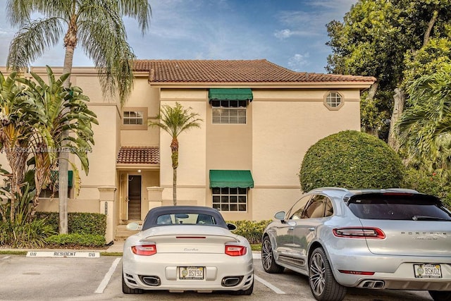 view of building exterior with uncovered parking