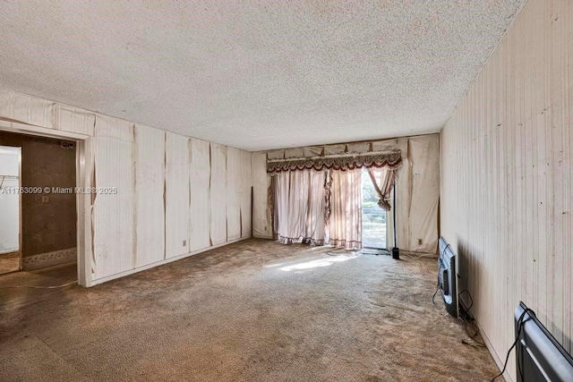 unfurnished room with a textured ceiling and carpet