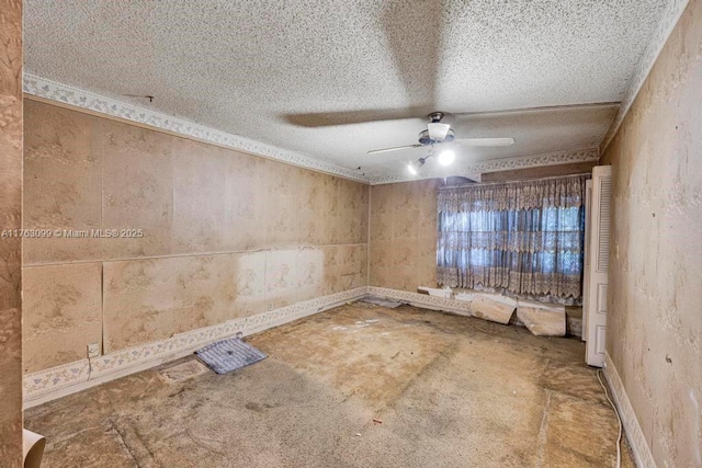 spare room with baseboards, a textured ceiling, and ceiling fan