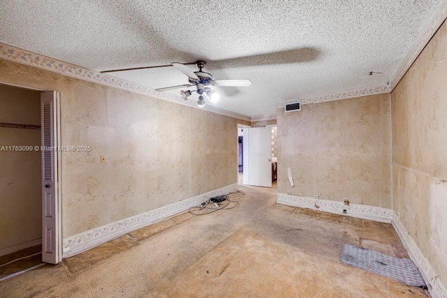 unfurnished room featuring visible vents, a textured ceiling, and ceiling fan