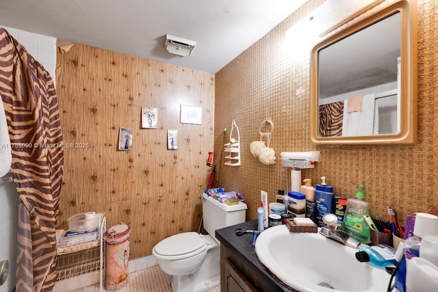 bathroom with tile patterned flooring, toilet, and vanity