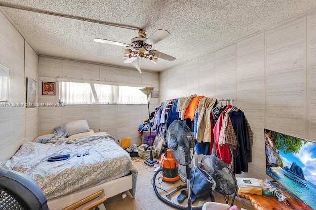 carpeted bedroom with a textured ceiling and ceiling fan