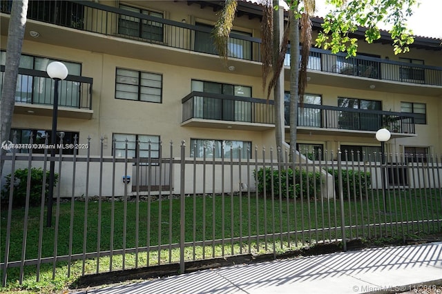 view of building exterior featuring a fenced front yard