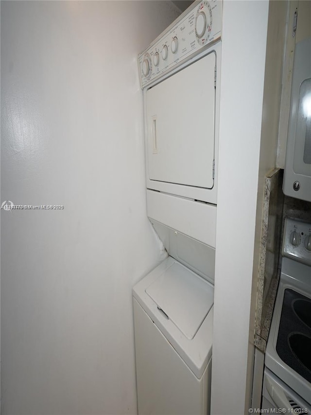 laundry area featuring laundry area and stacked washer / dryer