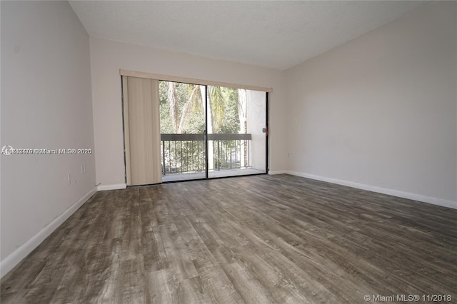 unfurnished room with wood finished floors and baseboards