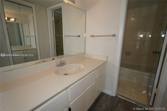 bathroom with vanity, wood finished floors, and baseboards