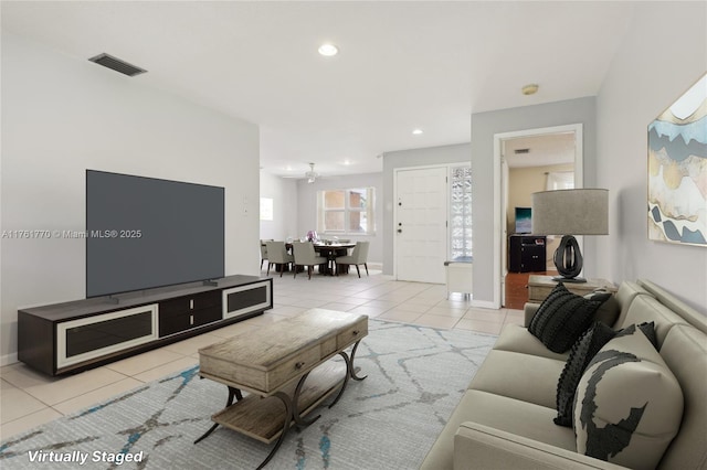 tiled living area featuring visible vents, recessed lighting, and baseboards