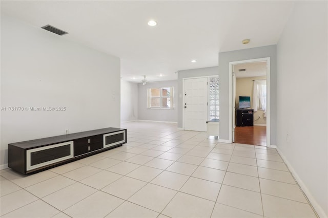 empty room featuring light tile patterned floors, visible vents, baseboards, and recessed lighting