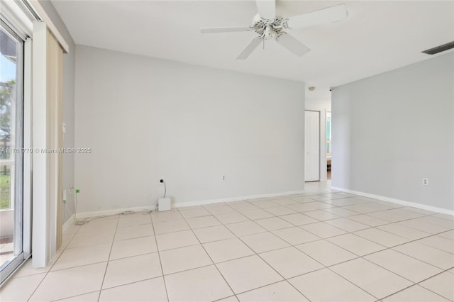 spare room featuring visible vents, baseboards, light tile patterned flooring, and a ceiling fan