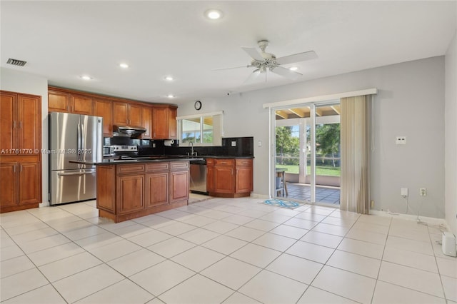 kitchen featuring a ceiling fan, visible vents, appliances with stainless steel finishes, under cabinet range hood, and dark countertops