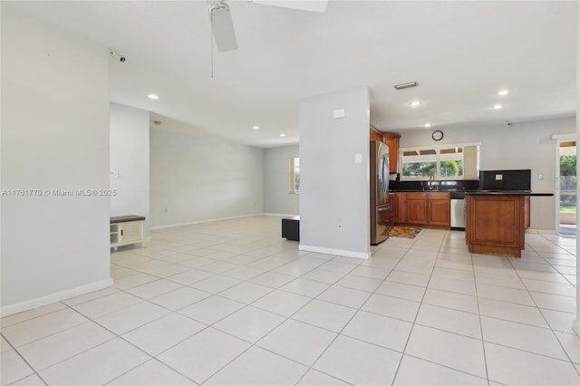 kitchen featuring dark countertops, visible vents, open floor plan, light tile patterned floors, and appliances with stainless steel finishes