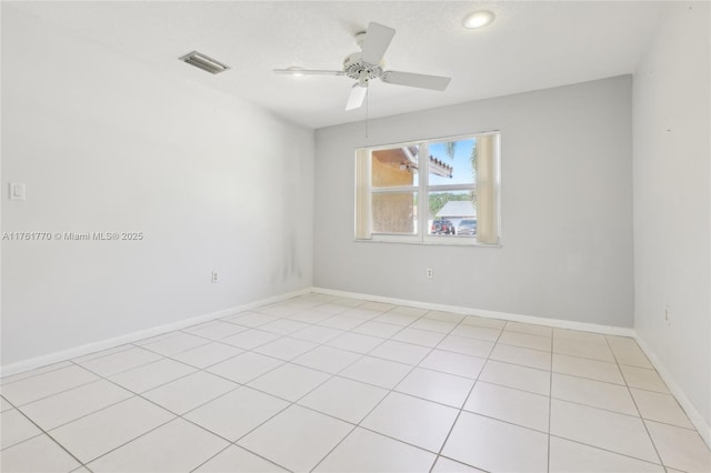 unfurnished room with visible vents, baseboards, and ceiling fan