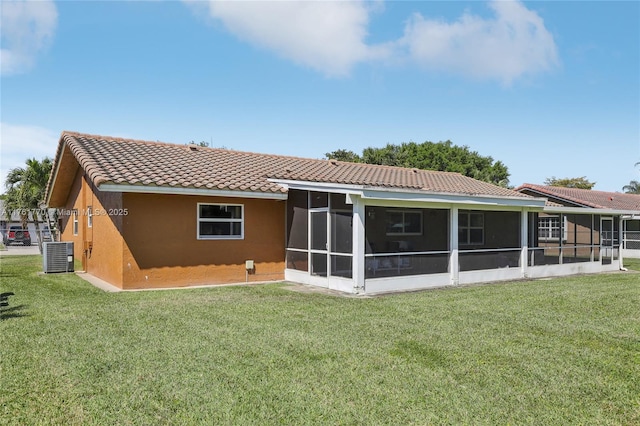 back of property featuring stucco siding, a tile roof, and a lawn