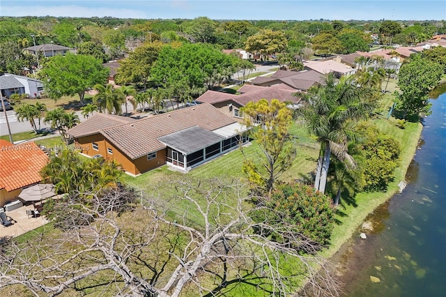 drone / aerial view with a residential view and a water view