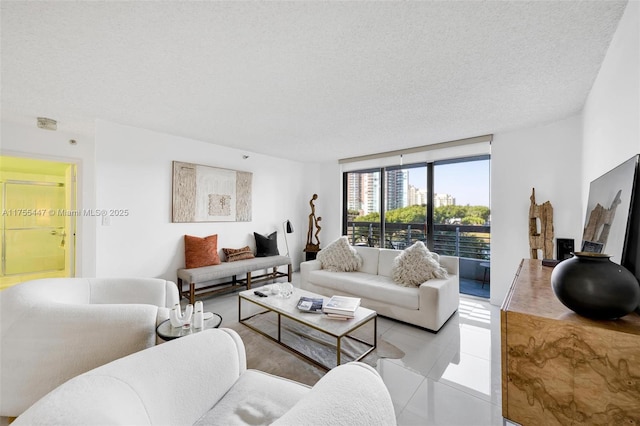 living area with light tile patterned floors and a textured ceiling