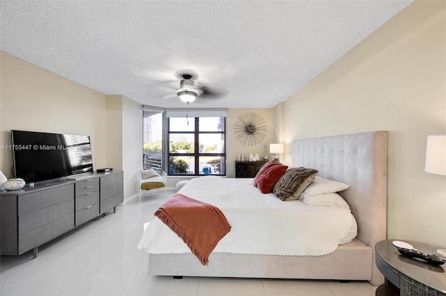 bedroom featuring light tile patterned floors, baseboards, a textured ceiling, and ceiling fan