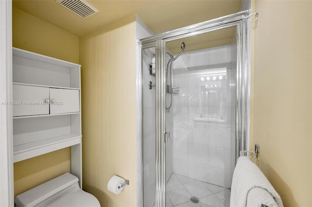 full bathroom with toilet, visible vents, and a stall shower