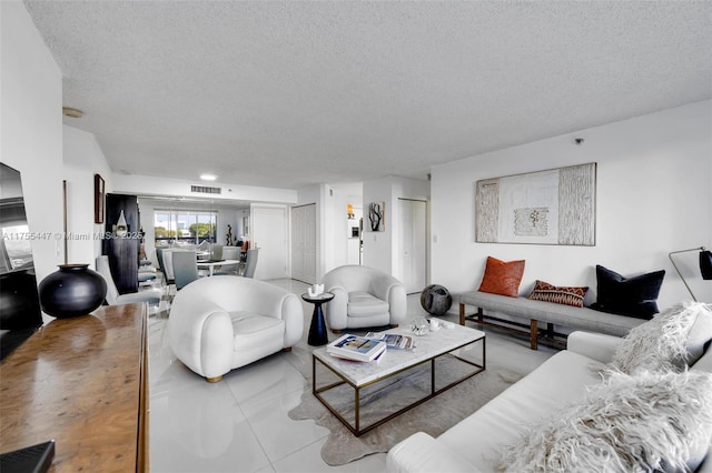 living room featuring visible vents and a textured ceiling