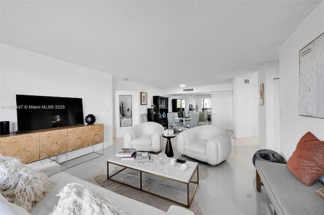 tiled living area with visible vents and a textured ceiling