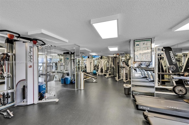 exercise room with a textured ceiling