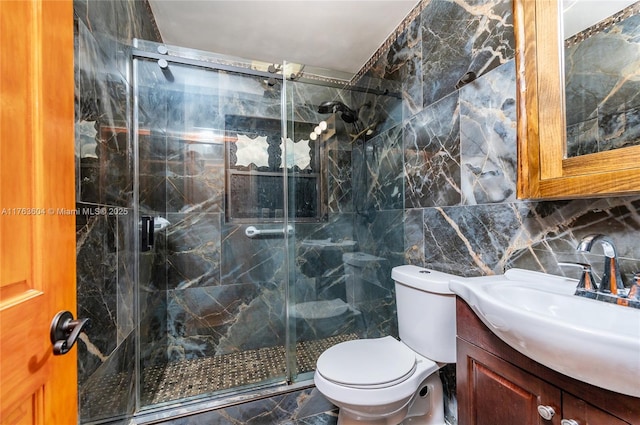 bathroom featuring vanity, a marble finish shower, tile walls, toilet, and backsplash