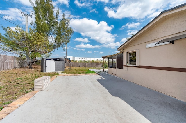 view of patio with a fenced backyard, a storage shed, and an outdoor structure