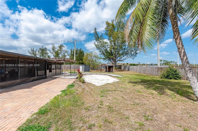 view of yard featuring a fenced backyard, an outdoor structure, and a shed