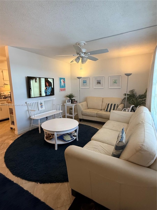 living room with a textured ceiling and a ceiling fan