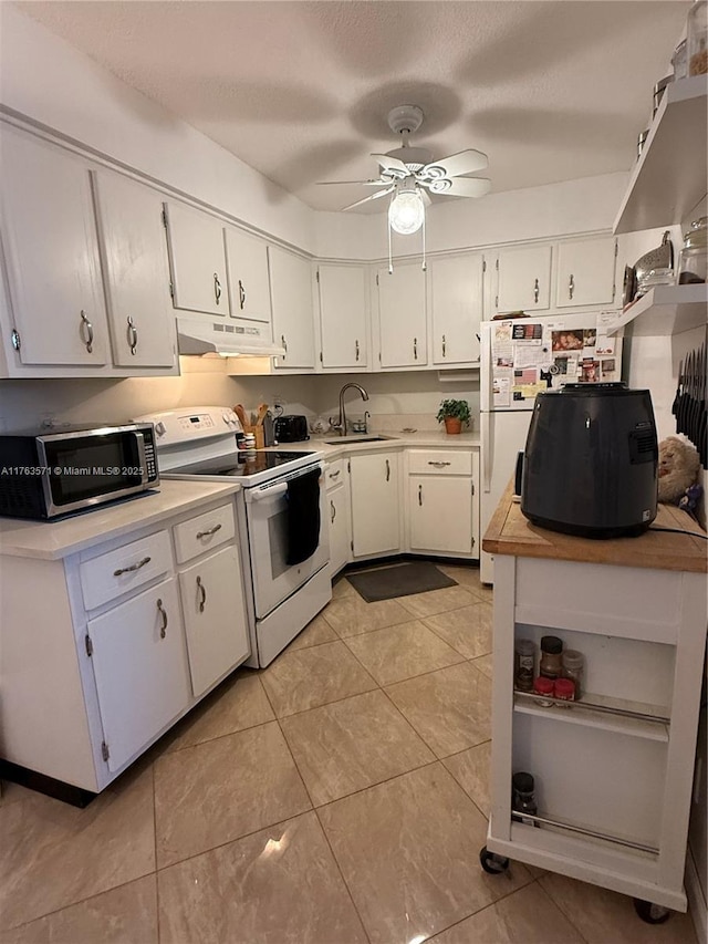 kitchen with electric stove, under cabinet range hood, a sink, light countertops, and ceiling fan