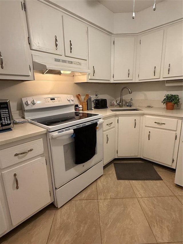 kitchen featuring electric stove, under cabinet range hood, a sink, white cabinetry, and light countertops