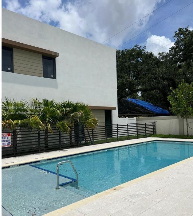 community pool featuring fence