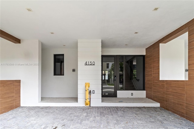 entrance to property with stucco siding and french doors