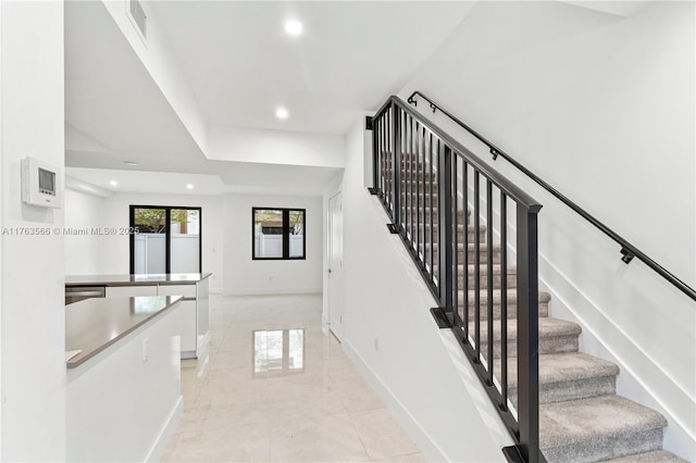 staircase with visible vents, recessed lighting, and baseboards