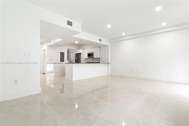 unfurnished living room with electric panel, recessed lighting, and baseboards