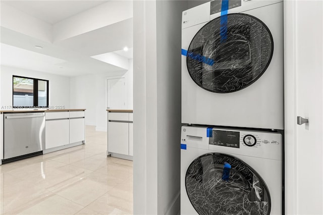 washroom featuring laundry area, stacked washer / drying machine, and marble finish floor